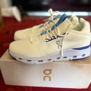 On Running Cream and Blue Athletic Shoes